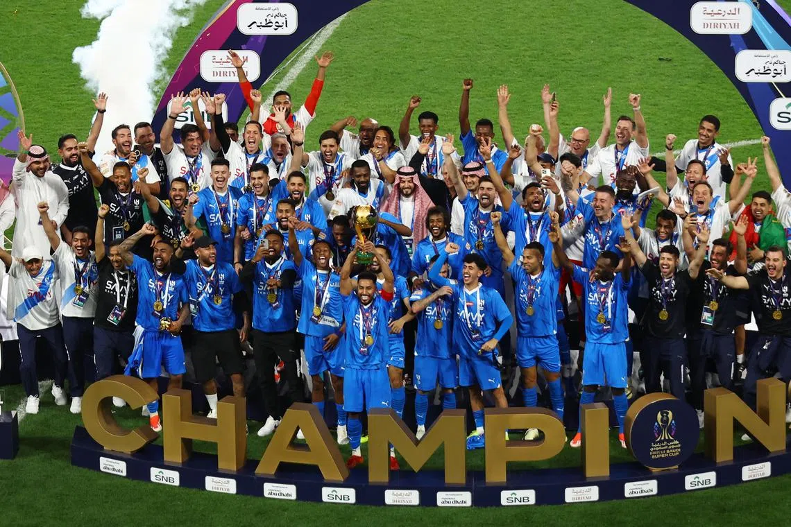 FILE PHOTO: Soccer Football - Saudi Super Cup - Final - Al Hilal v Al Ittihad - Mohammed Bin Zayed Stadium, Abu Dhabi, United Arab Emirates - April 11, 2024 Al Hilal's Salem Al-Dawsari lifts the trophy with teammates after winning the Saudi Super Cup final REUTERS/Rula Rouhana/File Photo