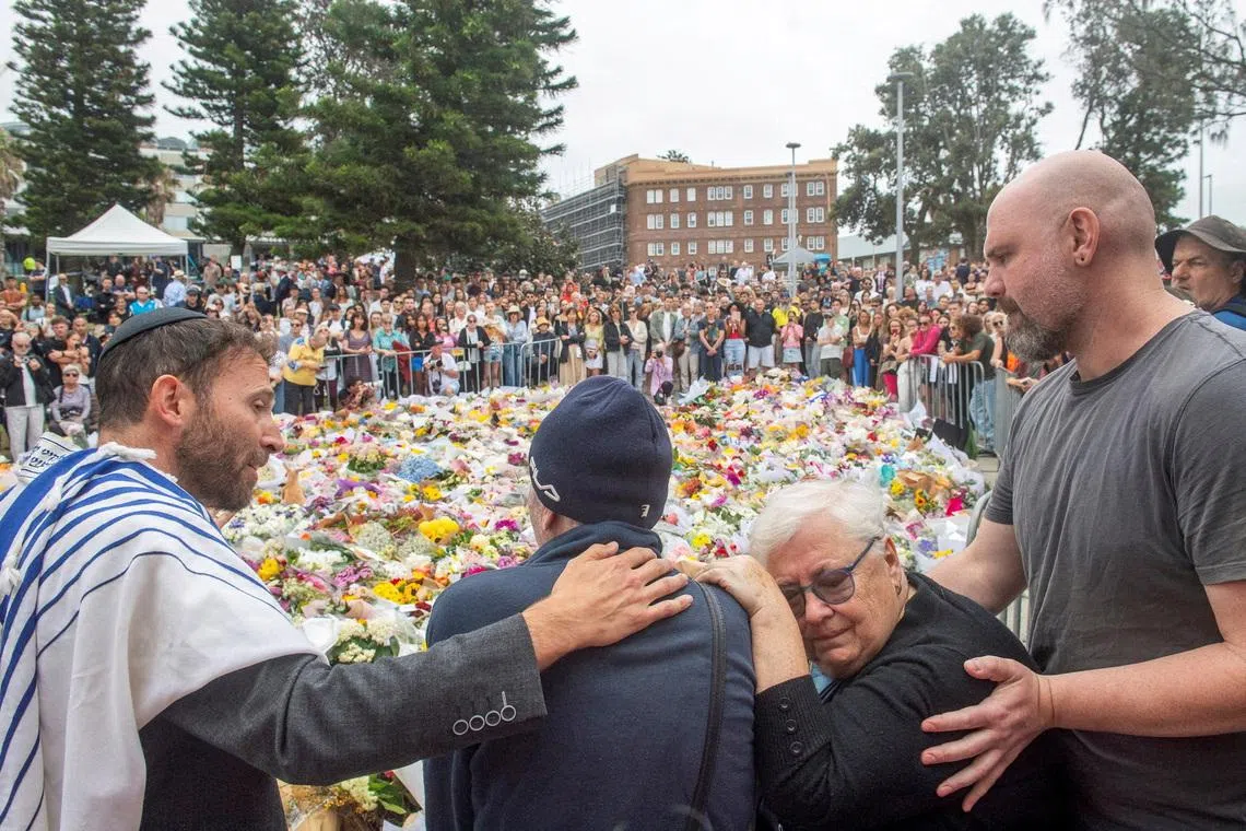 FILE PHOTO: Grandparents of 10-year-old Matilda, who was killed during a mass shooting targeting a Hanukkah celebration on Sunday, grieve at the floral memorial to honour the victims of the mass shooting at Bondi Beach, in Sydney, Australia, December 16, 2025. REUTERS/Jeremy Piper/File Photo