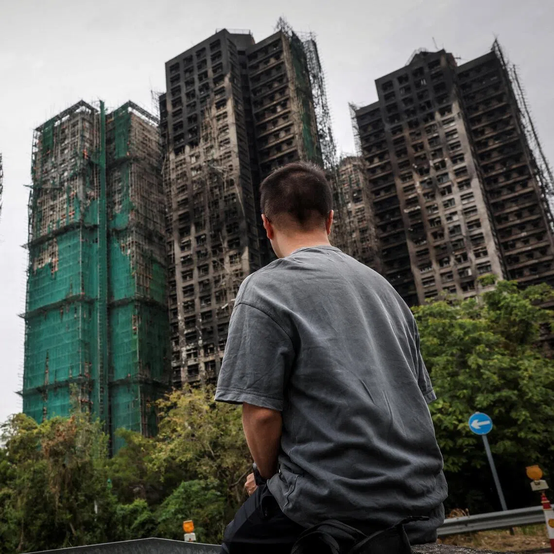 FILE PHOTO: J Wong, son of Wong, a 71-year-old man whose image was captured during the deadly Wang Fuk Court fire in a widely published Reuters photograph, poses for a photo near the housing complex during an interview in Tai Po, Hong Kong, China, November 30, 2025. REUTERS/Tyrone Siu/File Photo