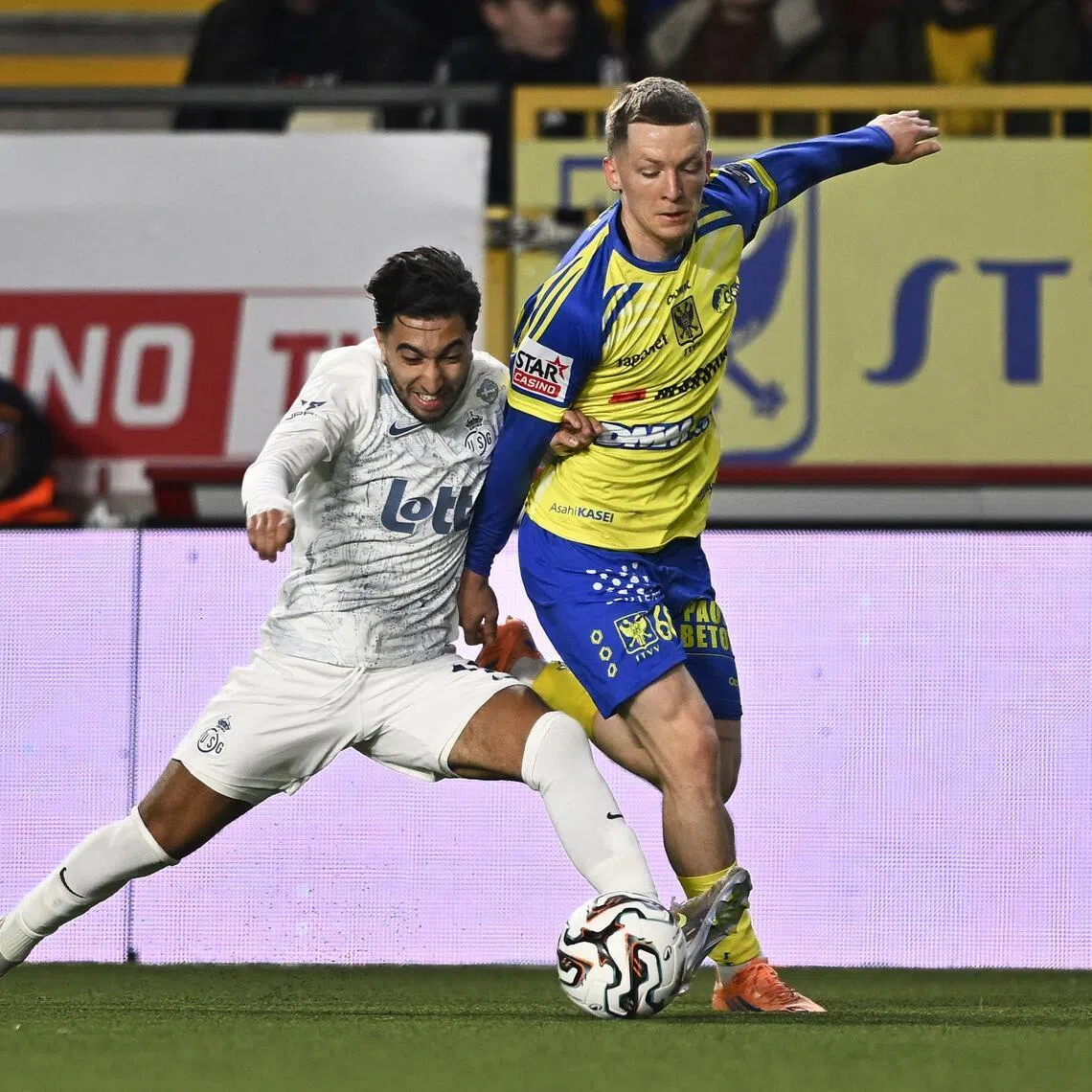 Union Saint-Gilloise midfielder Anouar Ait El Hadj trying to dispossess St Truiden defender Robert-Jan Vanwesemael in their Belgian ProLeague football match in Sint-Truiden on March 22, 2026.