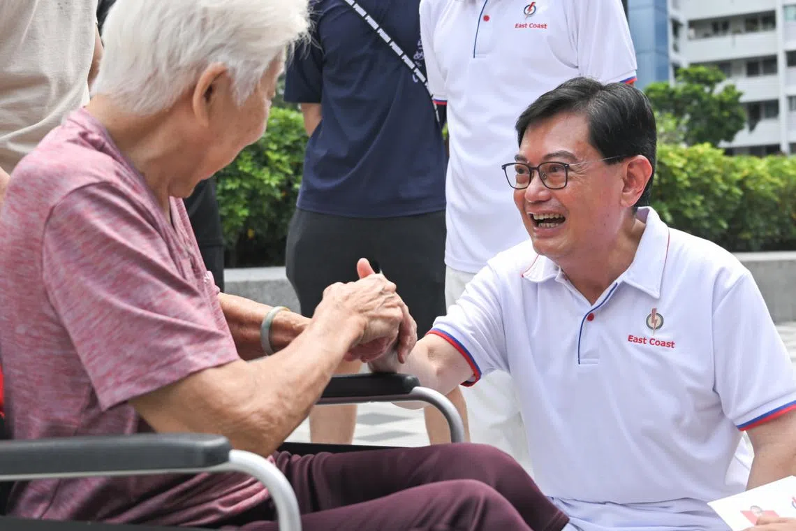 Deputy Prime Minister Heng Swee Keat greeting residents at a walkabout at Block 216 Bedok Food Centre on May 1.