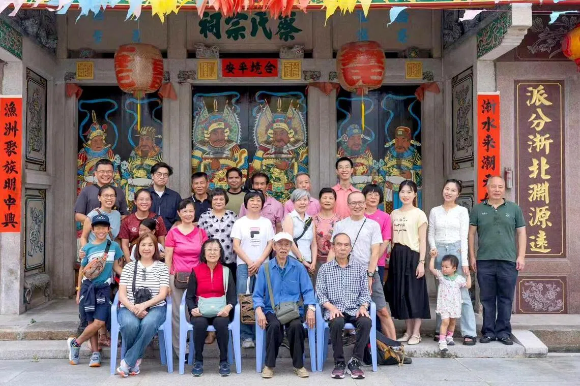 Jasmine Goh-Chew (third row, first from left), her husband Raymond Chew (top row, first from left) and her parents Chua Kee Chu and Goh Kian Chen (front row, second and third from left) with other relatives outside the Chua ancestral home.