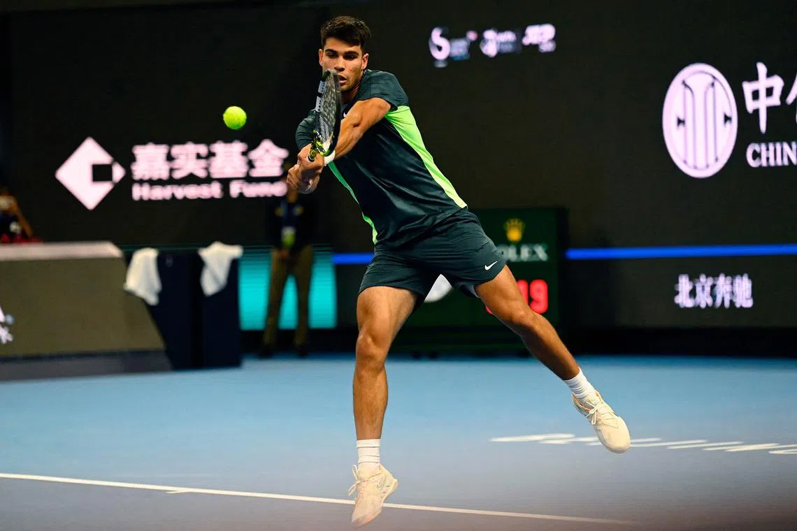 Spain’s Carlos Alcaraz hits a return against Germany’s Yannick Hanfmann.