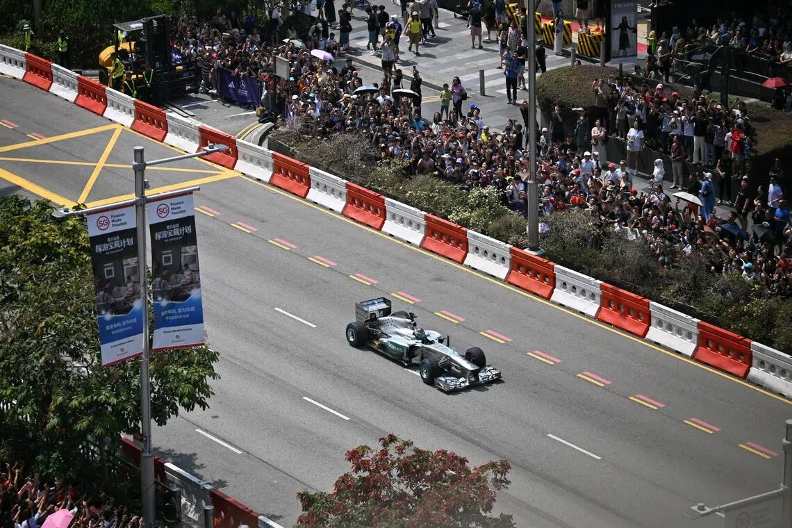 Mercedes reserve driver Fred Vesti driving past fans in front of Takashimaya during adidas’ Orchard Ignition event on Aug 30.