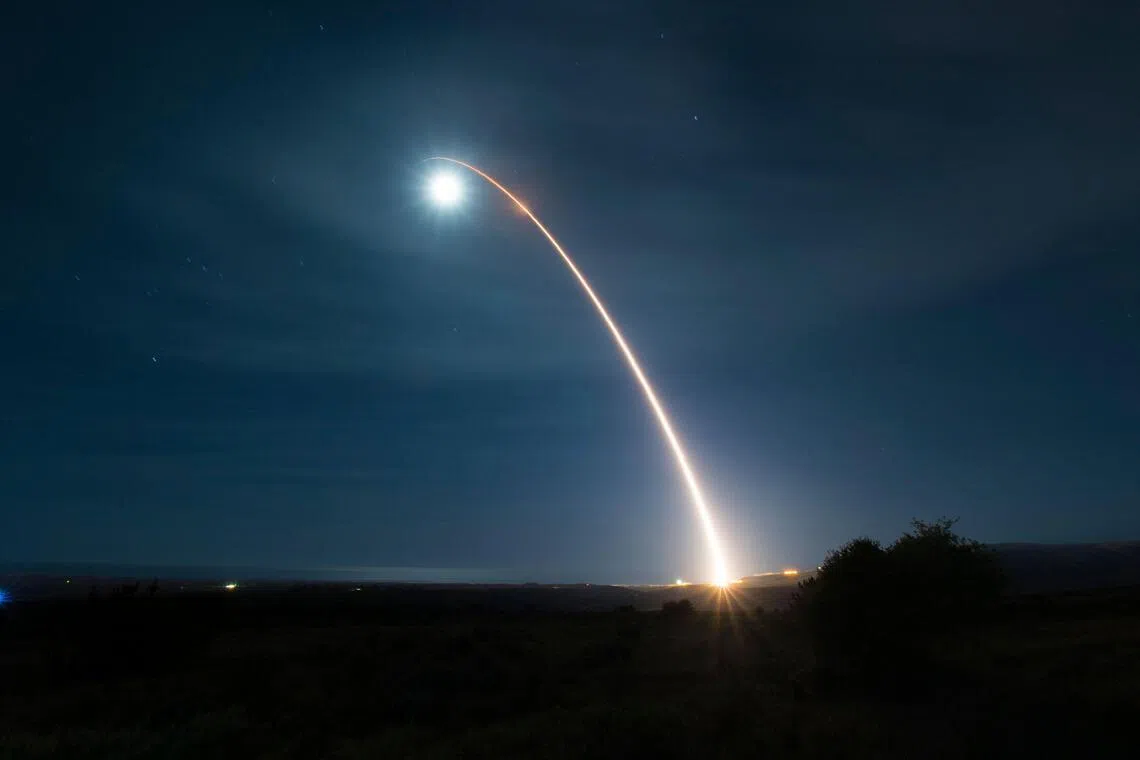 (FILES) This US Air Force handout photograph shows an unarmed Minuteman III intercontinental ballistic missile as it launches during a developmental test at 12:33 a.m. Pacific Time on February 5, 2020, at Vandenberg Air Force Base, California. Russia vowed on February 4, 2026,  to act "responsibly" should its last nuclear treaty with the United States expire on February 5, amid mounting fears the agreement's collapse could spur a new arms race between the top nuclear powers. The New START agreement, signed in 2010, limits the number of nuclear warheads each side can deploy. (Photo by Clayton WEAR / US AIR FORCE / AFP) / RESTRICTED TO EDITORIAL USE - MANDATORY CREDIT "AFP PHOTO /US AIR FORCE /CLAYTON WEAR/ HANDOUT " - NO MARKETING - NO ADVERTISING CAMPAIGNS - DISTRIBUTED AS A SERVICE TO CLIENTS