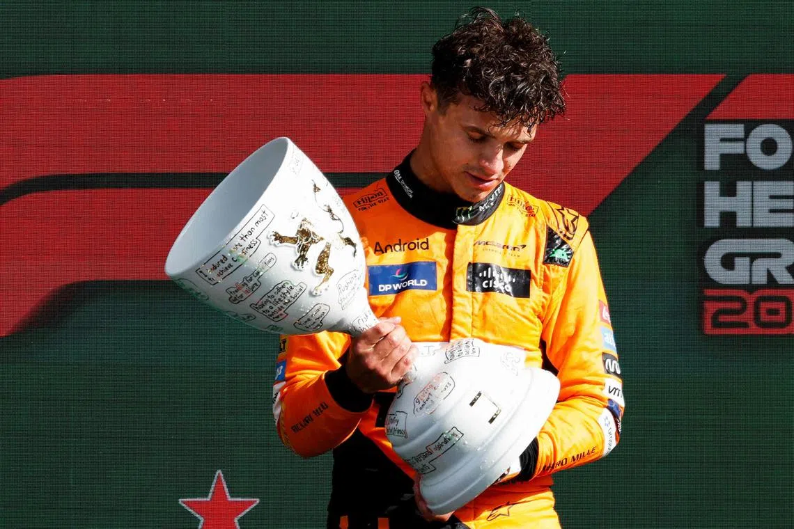 Lando Norris of McLaren celebrates on the podium after winning the Dutch Grand Prix.