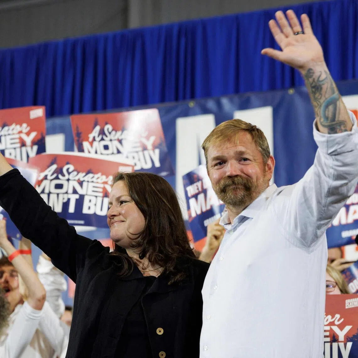 Democratic US Senate candidate Graham Platner and his wife Amy Gertner wave to supporters in Blue Hill, Maine. 