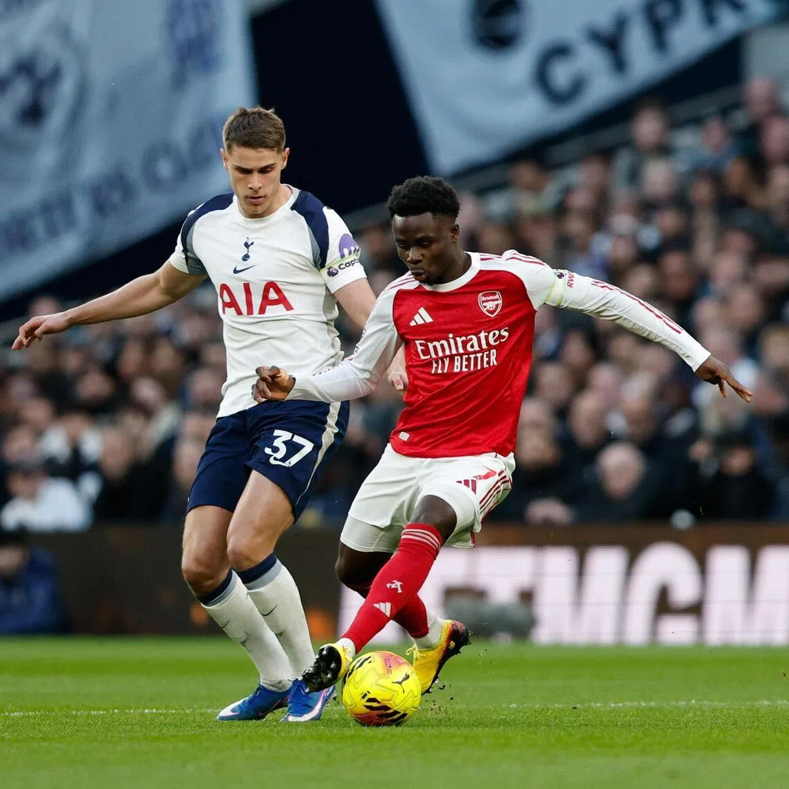 Micky van de Ven of Tottenham (L) in action against Bukayo Saka of Arsenal during the English Premier League match between Tottenham Hotspur and Arsenal FC, in London on Feb 22. 