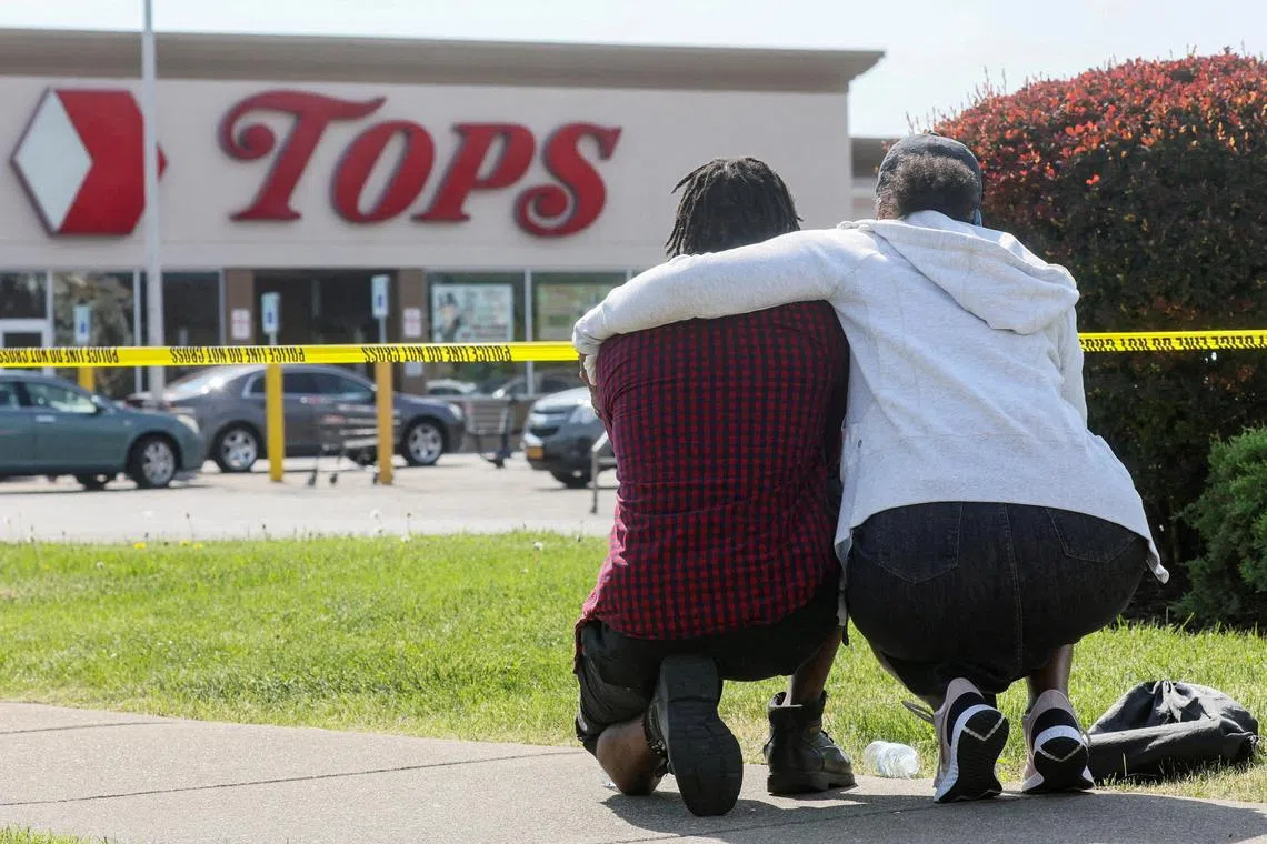 FILE PHOTO: Mourners react while attending a vigil for victims of the shooting at a TOPS supermarket in Buffalo, New York, U.S. May 15, 2022. REUTERS/Brendan McDermid//File Photo