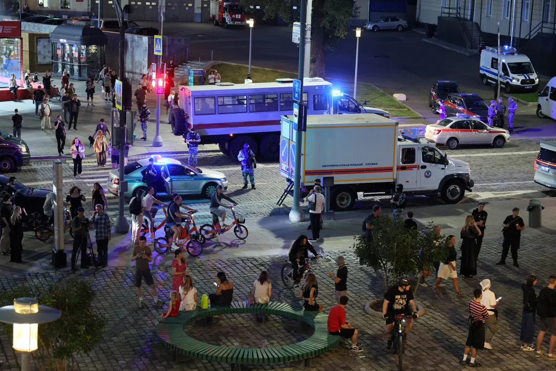 Law enforcement officers and emergency services personnel near the site of an explosion at a restaurant in central Moscow on Aug 1.