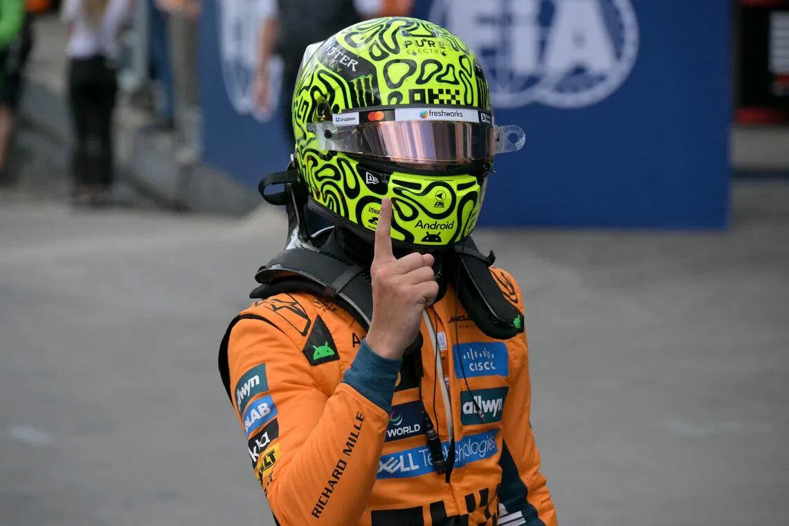 TOPSHOT - McLaren's British driver Lando Norris celebrates after getting the pole position during the qualifying session of the Sao Paulo Formula One Grand Prix at the Jose Carlos Pace racetrack, aka Interlagos, in Sao Paulo, Brazil on November 8, 2025. (Photo by Nelson ALMEIDA / AFP)