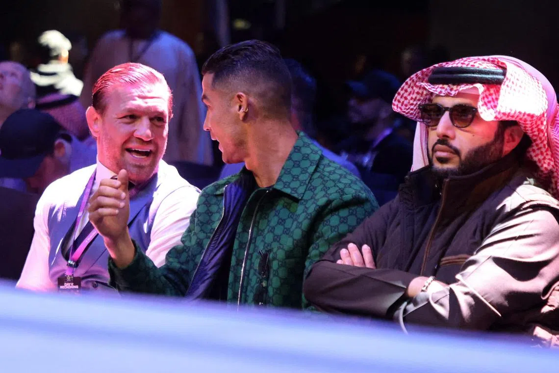 Conor McGregor and Cristiano Ronaldo chatting in the stands before the boxing fight between Anthony Joshua and Otto Wallin at the Kingdom Arena in Riyadh, Saudi Arabia on Dec 23.