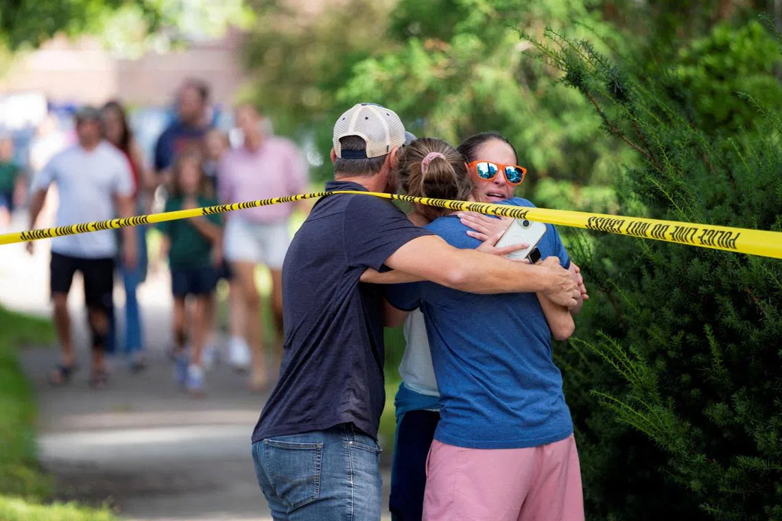 Families and loved ones reuniting outside the police barricades, after a shooting on Aug 27 at Annunciation Church, which is also home to an elementary school, in Minneapolis.  