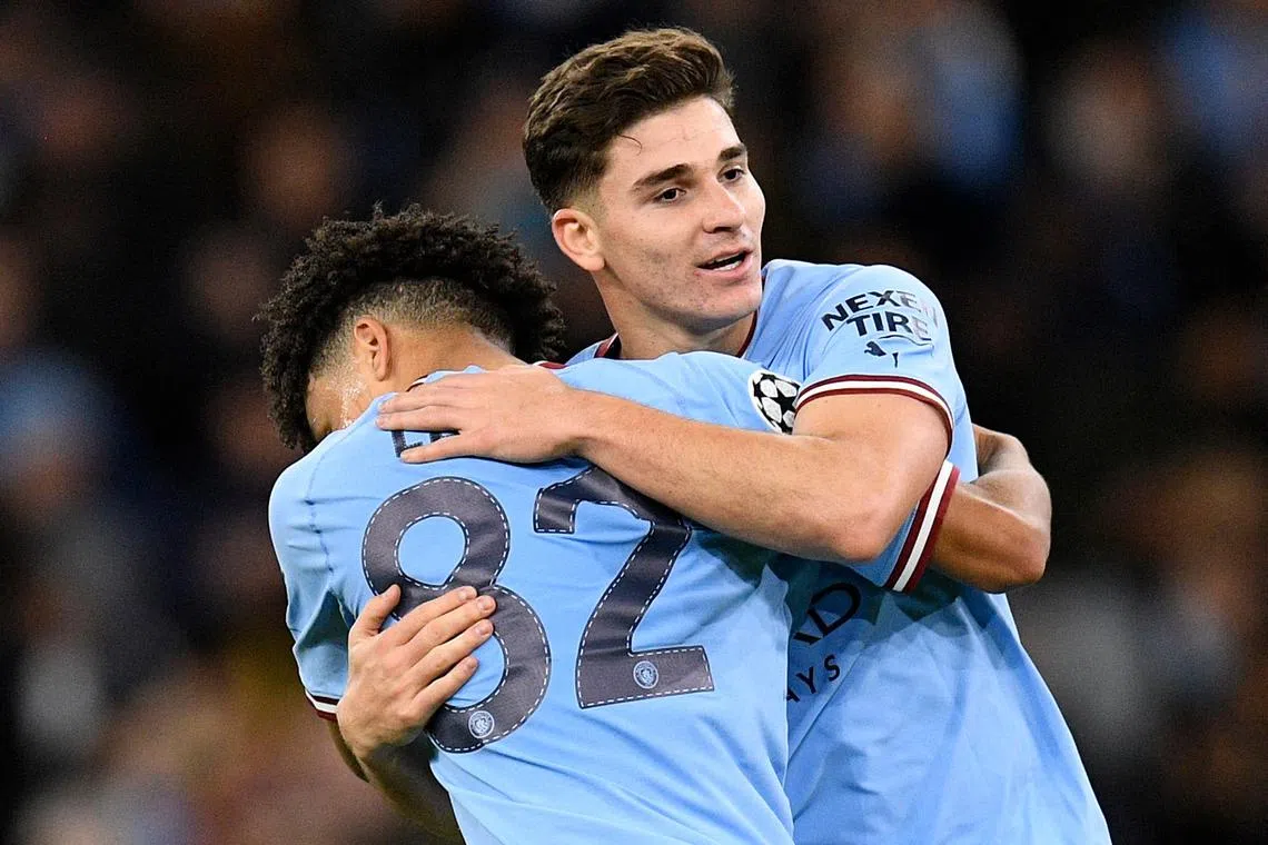 Manchester City's Julian Alvarez (right) celebrates scoring his team's second goal with teammate Rico Lewis.