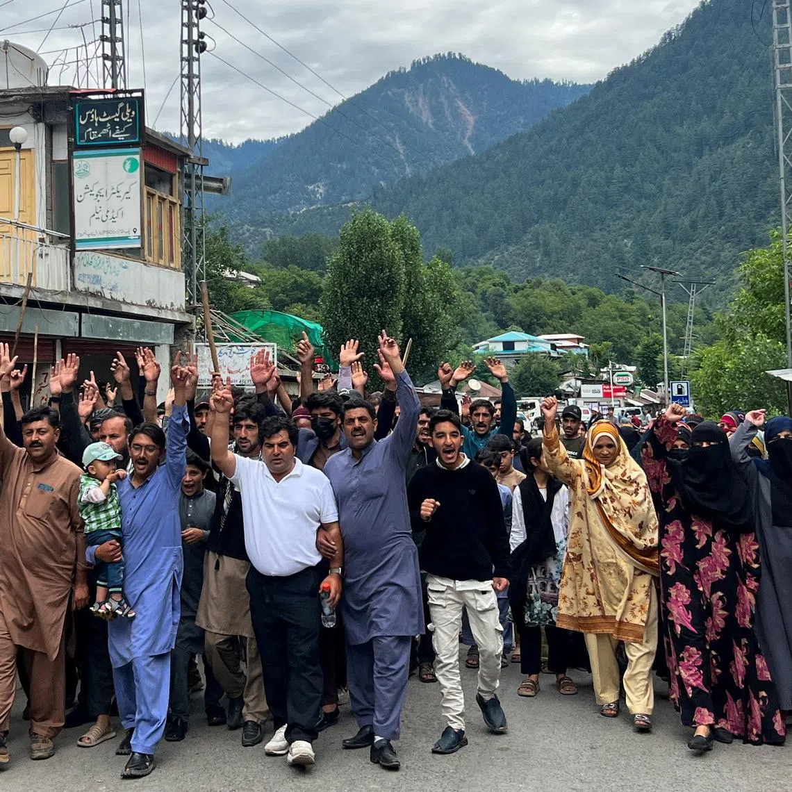 FILE PHOTO: People chant slogans as they walk during a protest and shutter-down strike called by the banned Joint Awami Action Committee (JAAC), an alliance of civil society groups, in Neelum Valley, Pakistani Kashmir, June 21, 2026. Picture taken with a mobile phone. REUTERS/Naseer ud Din/File Photo
