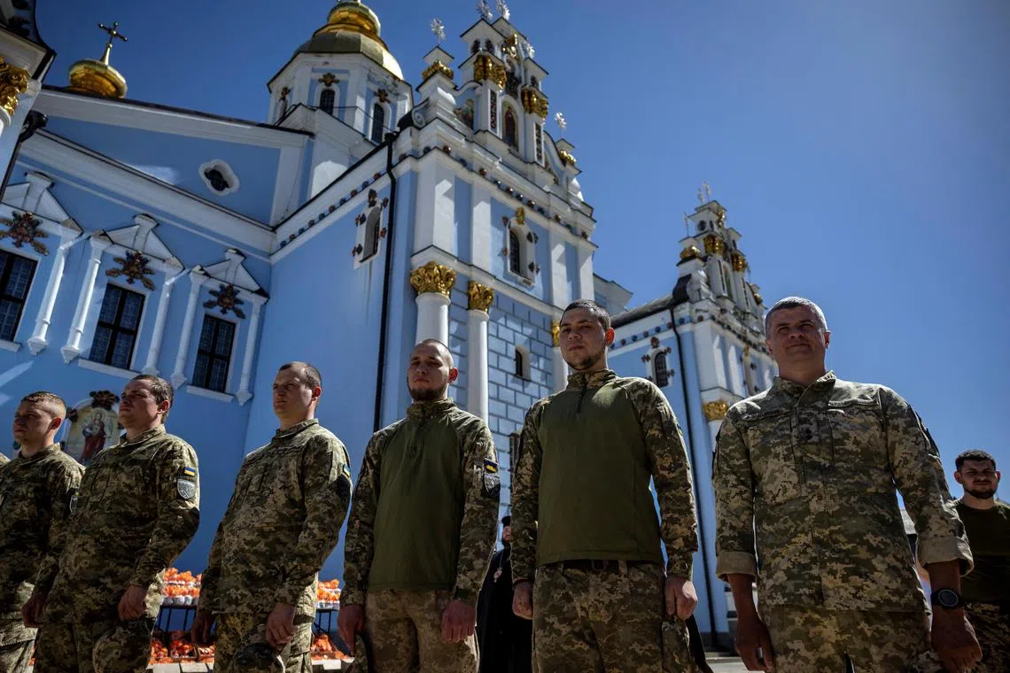 Ukrainian soldiers attending an Orthodox Easter service at St Michael's Cathedral in Kyiv, on May 2, 2024.