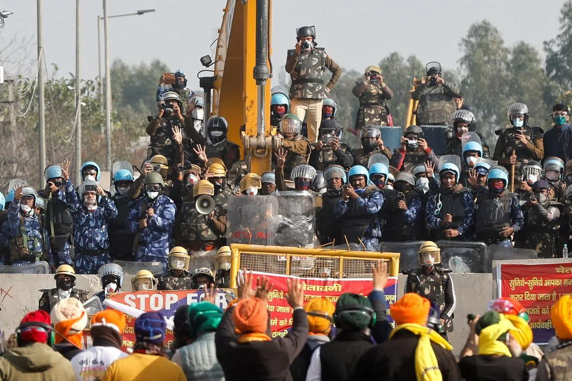 FILE PHOTO: Farmers gesture towards police officers at the site of a protest as they march towards New Delhi to press for better crop prices, at Shambhu barrier, a border crossing between Punjab and Haryana states, India, February 21, 2024. REUTERS/Francis Mascarenhas/File Photo