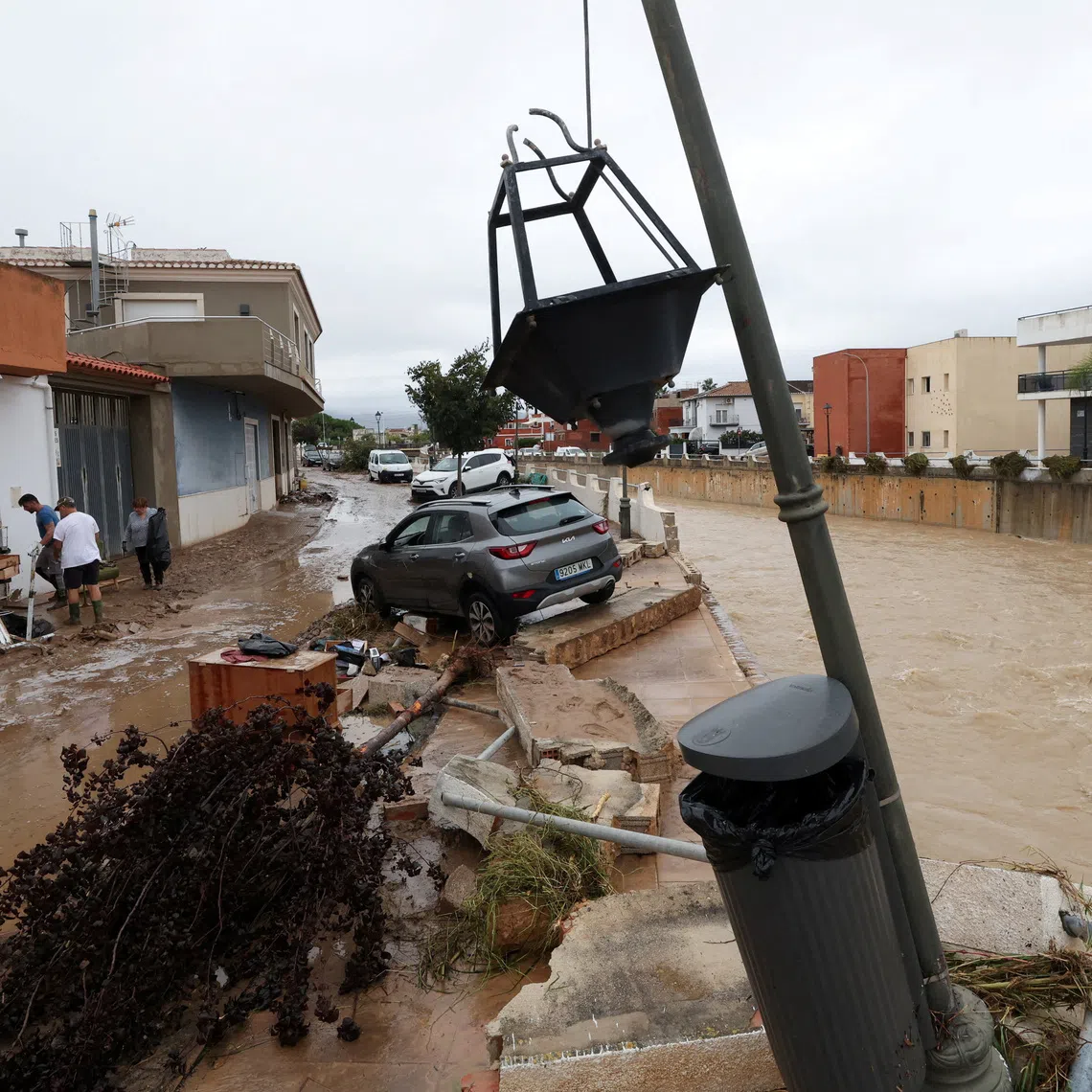 A car on the damaged bank of a waterway, following torrential rains, which caused floods in eastern Spain, in Els Poblets, Spain, October 19, 2026. REUTERS/Eva Manez