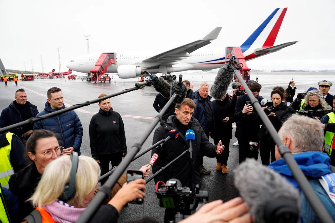 French President Emmanuel Macron speaks to members of media as he arrives at Nuuk Airport in Nuuk, Greenland, June 15, 2025. Ritzau Scanpix/Mads Claus Rasmussen/via REUTERS