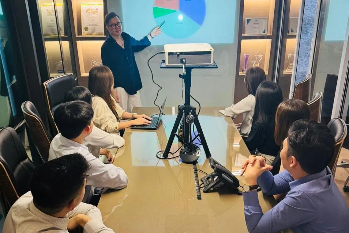 Mr Americ See (standing), managing director of ASL Global, shares that quality service helps the company stand out in a highly competitive industry.