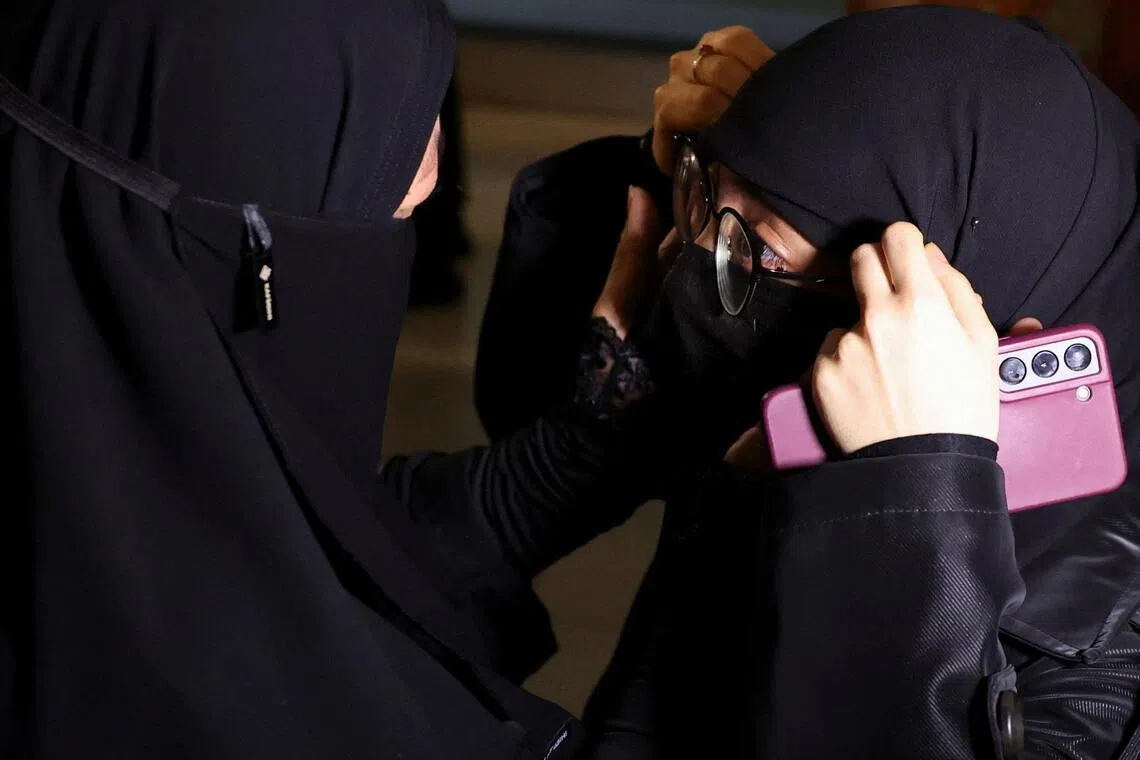 A mother and daughter reunite after the first batch of Indonesians evacuated from Iran arrives at Soekarno Hatta International Airport in Jakarta on March 10.