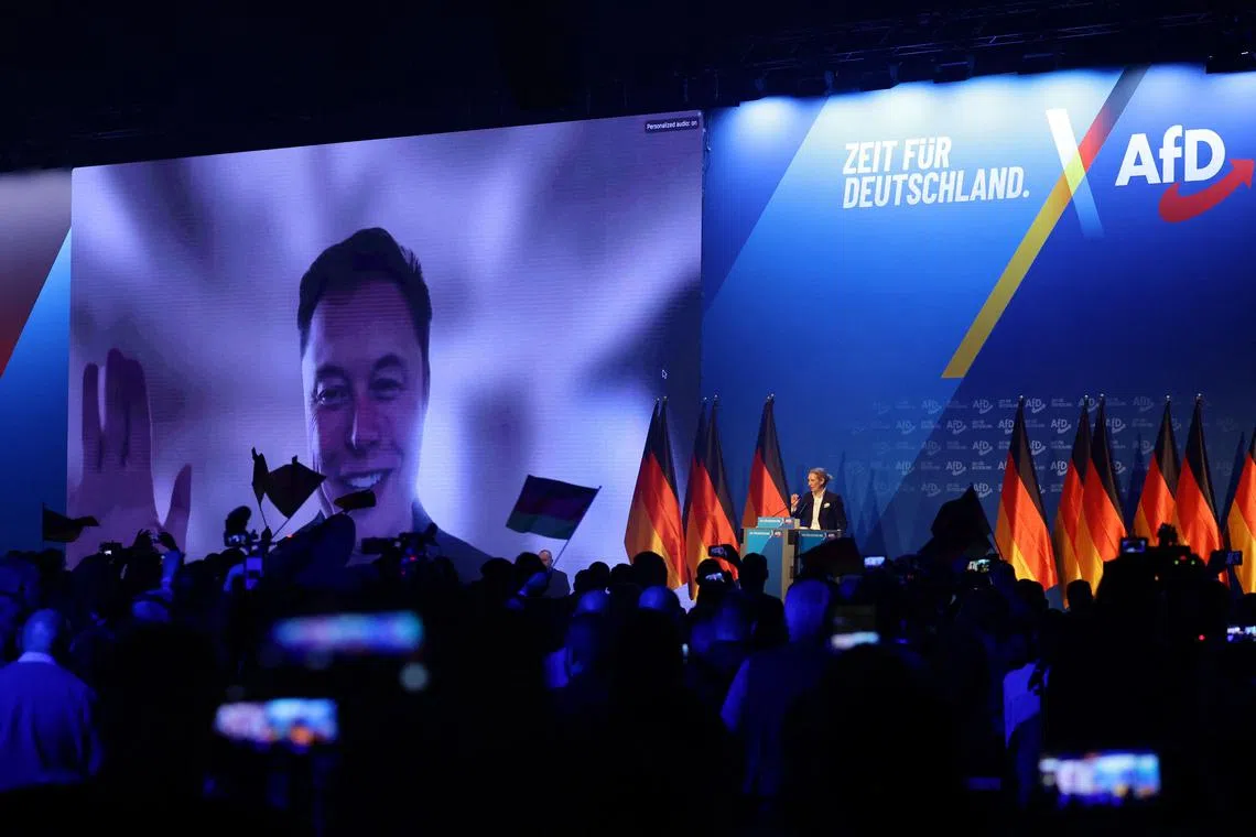 US tech billionaire and businessman Elon Musk (L) is seen on a large screen as Alice Weidel, co-leader of Germany's far-right Alternative for Germany (AfD) party, addresses an election campaign rally in Halle, eastern Germany on January 25, 2025. (Photo by AFP)