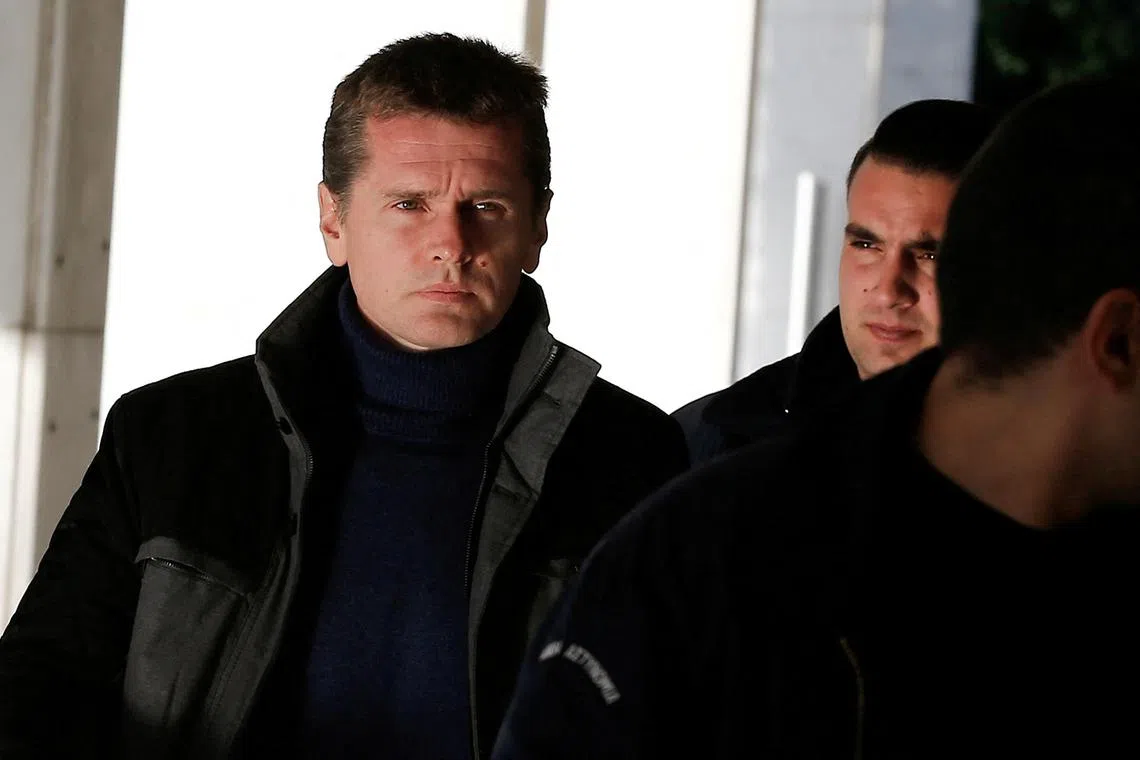 FILE PHOTO: Alexander Vinnik is escorted by police officers to a court in Athens, Greece December 13, 2017. REUTERS/Costas Baltas/File Photo