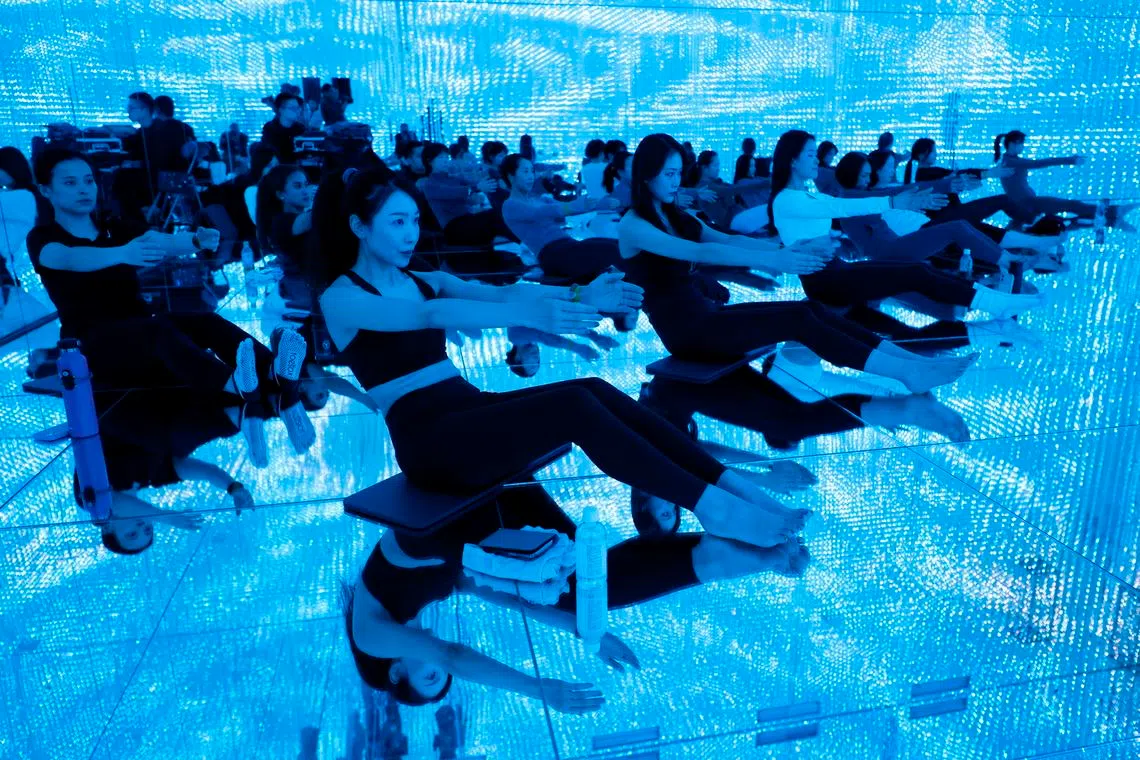 Participants practicing yoga during a special session held inside the immersive art space 'teamLab Borderless' at Azabudai Hills in Tokyo, Japan, on Feb 24, 2026. 