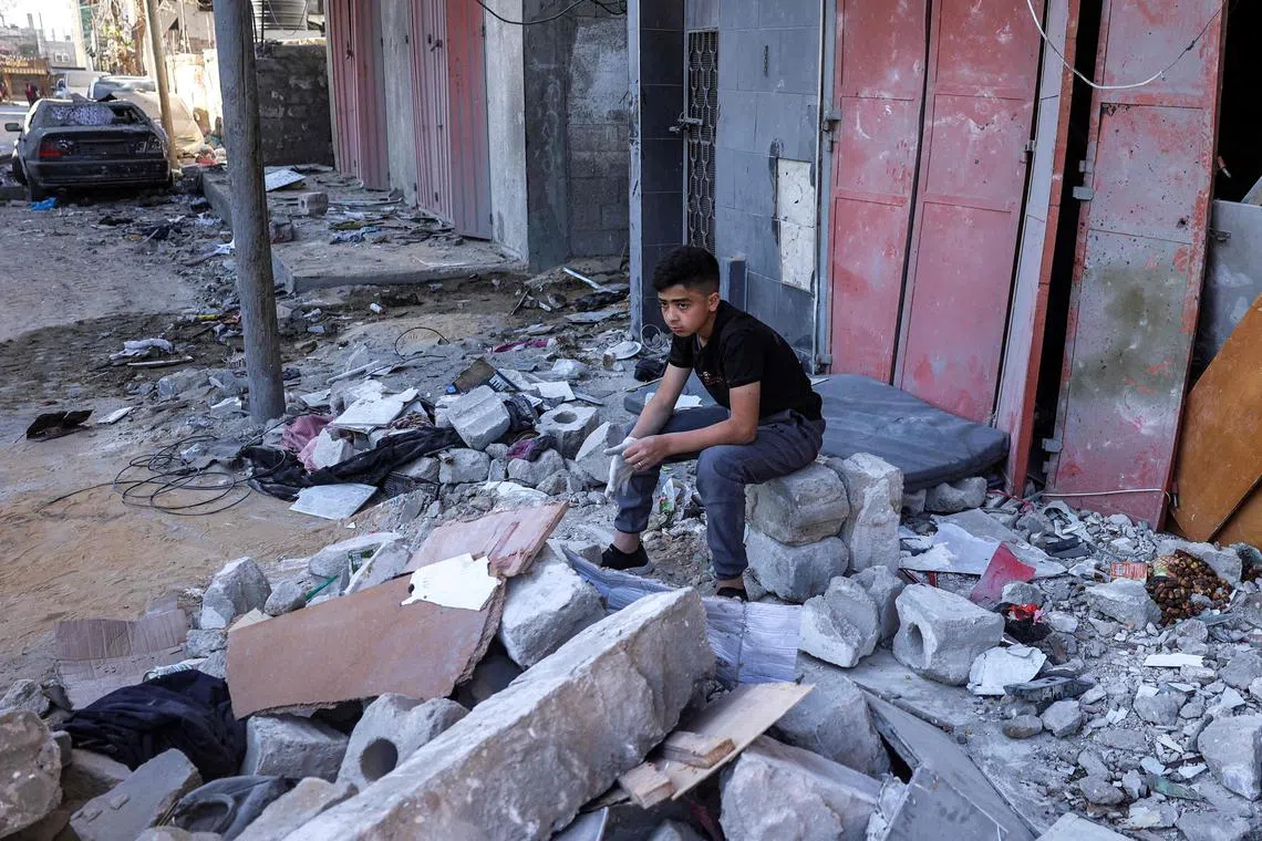 A boy sitting amid the rubble of a building hit by Israeli bombardment in Rafah, in the southern Gaza Strip, on May 8, 2024.