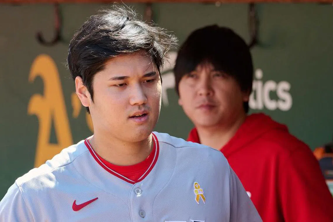 Sep 3, 2023; Oakland, California, USA; Los Angeles Angels designated hitter Shohei Ohtani (17) and interpreter Ippei Mizuhara stand in the dugout before the game between the Los Angeles Angels and the Oakland Athletics at Oakland-Alameda County Coliseum. Mandatory Credit: Robert Edwards-USA TODAY Sports/File Photo