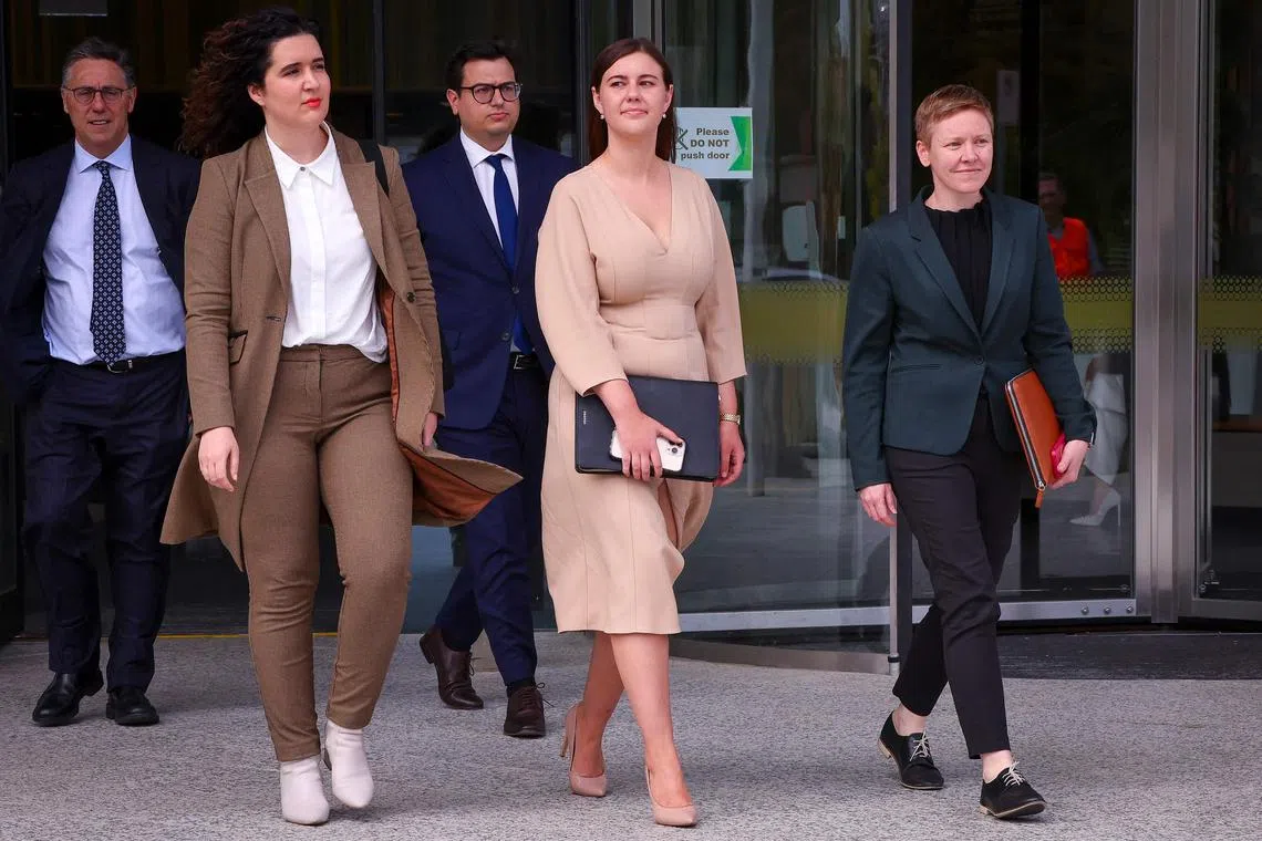  In this photo taken on Oct 14, 2022, Ms Brittany Higgins (C) is seen leaving a Canberra court with her legal team.