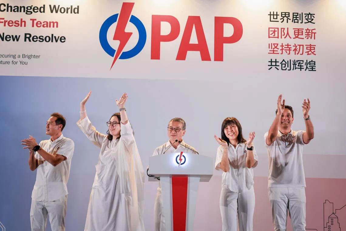 The PAP's East Coast GRC candidates (from left) Tan Kiat How, Hazlina Abdul Halim, Edwin Tong, Jessica Tan and Dinesh Vasu Dash thanking their supporters at Bedok Stadium on May 4.