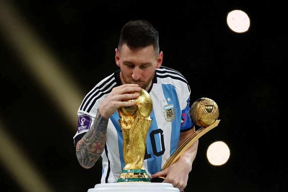 FILE PHOTO: Soccer Football - FIFA World Cup Qatar 2022 - Final - Argentina v France - Lusail Stadium, Lusail, Qatar - December 18, 2022 Argentina's Lionel Messi kisses the World Cup trophy after receiving the Golden Ball award as he celebrates after winning the World Cup REUTERS/Kai Pfaffenbach/File Photo