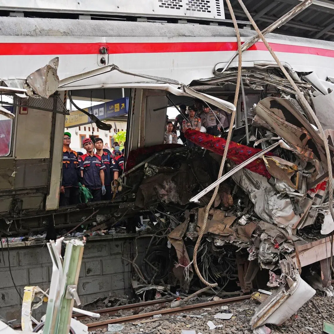 Workers at the site of the collision between two trains in Bekasi, on the outskirts of Jakarta, Indonesia. Sixteen people were killed, while 88 were wounded in the crash, which occurred on the night of April 27.