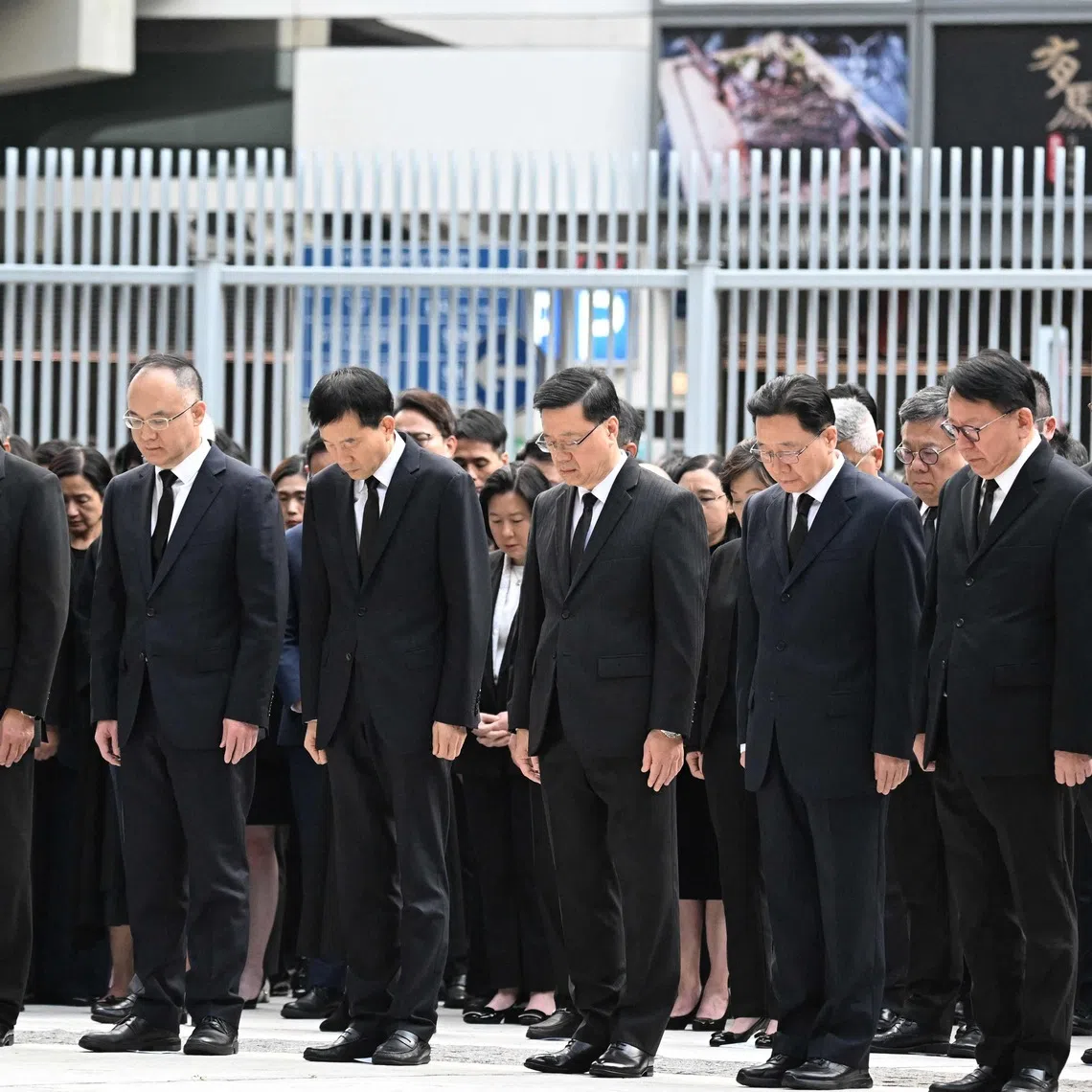 Hong Kong's Chief Executive John Lee (centre) and other government officials observing three minutes of silence to mourn victims of the Wang Fuk Court residential estate fire on Nov 29.