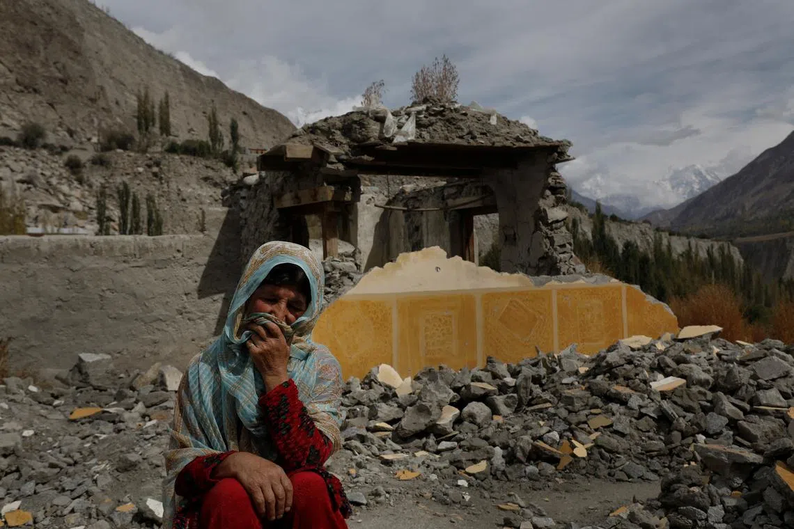Dilshad Bano, 51, sitting on the floor near her house which was damaged after a Glacial Lake Outburst Flooding (GLOF) incident, in Hassanabad village, Hunza valley, in the Karakoram mountain range in the Gilgit-Baltistan region of Pakistan, Oct 9, 2023. Pakistan is among the world's most at-risk countries from glacial lake floods, with 800,000 people living within 15km (9.3 miles) of a glacier. Many residents of the Karakorams built their homes on lush land along rivers running off glaciers.    