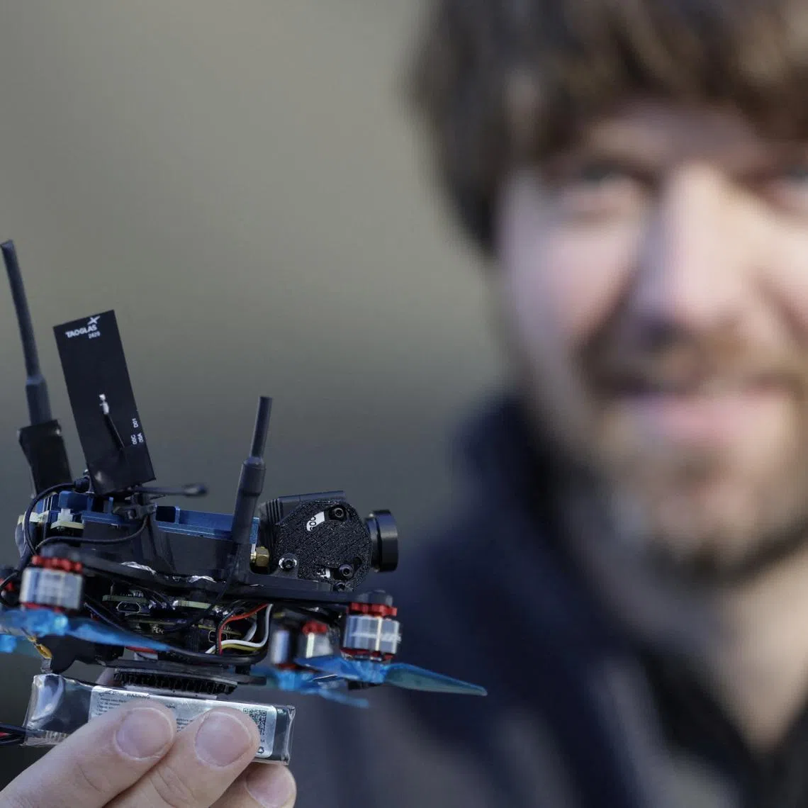 Dutch drone pilot Ralph Hogenbirk holds a FPV drone, used for capturing action in the sliding center, during an interview with Reuters in Cortina d'Ampezzo, Italy, February 13, 2026. REUTERS/Leonhard Foeger