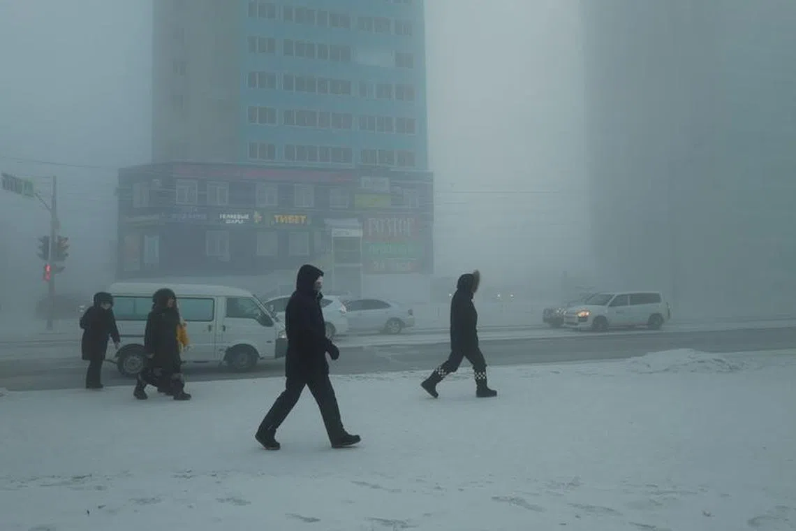 Pedestrians walk along a street on a frosty day in Yakutsk, Russia, December 5, 2023. Temperatures in parts of the Sakha Republic, also known as Yakutia and located in the northeastern part of Siberia, went below minus 50 degrees Celsius (minus 58 degrees Fahrenheit) on December 5. REUTERS/Roman Kutukov