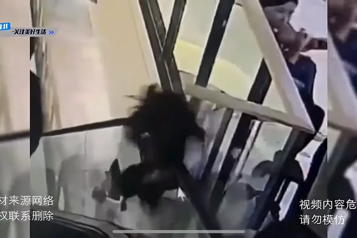 The glass panel the girl was leaning on had given way. 