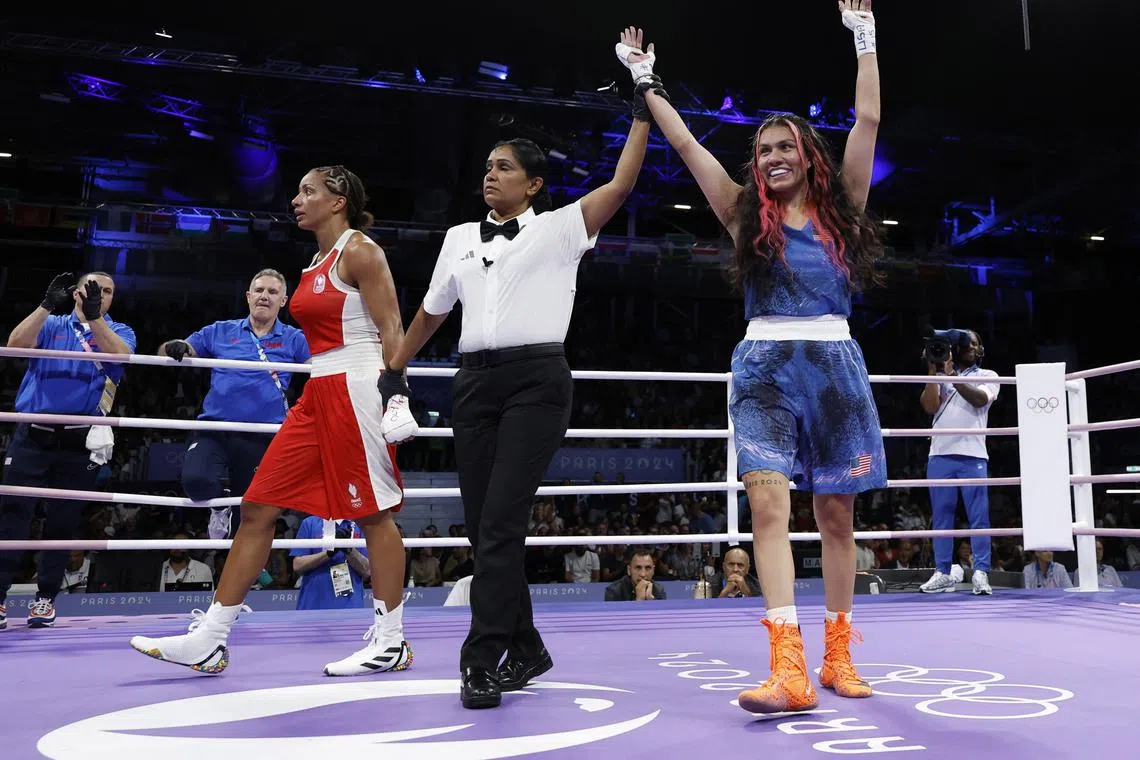 Paris 2024 Olympics - Boxing - Women's 60kg - Prelims - Round of 32 - North Paris Arena, Villepinte, France - July 27, 2024. Jajaira Gonzalez of United States has her hand raised after winning the bout against Estelle Mossely of France REUTERS/Peter Cziborra