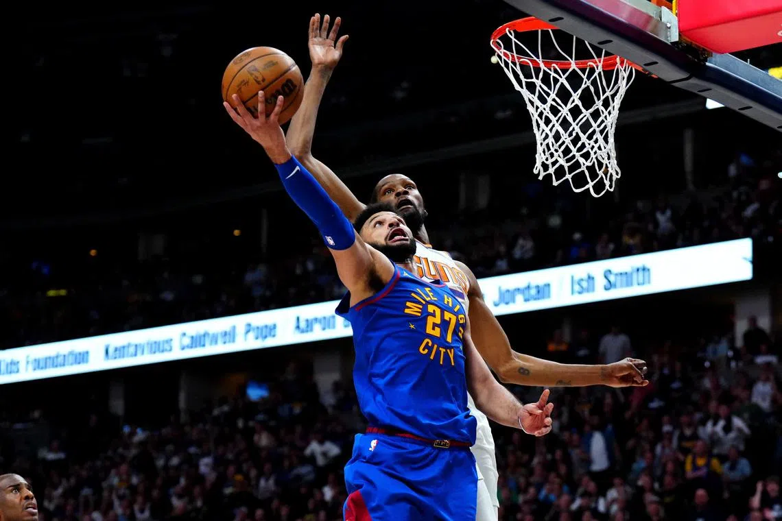Denver Nuggets guard Jamal Murray shooting the ball past Phoenix Suns forward Kevin Durant in the second half of Game 1 of their National Basketball Association Western Conference semi-final series on Saturday. Denver won 125-107 with Murray tallying a game-high 34 points.