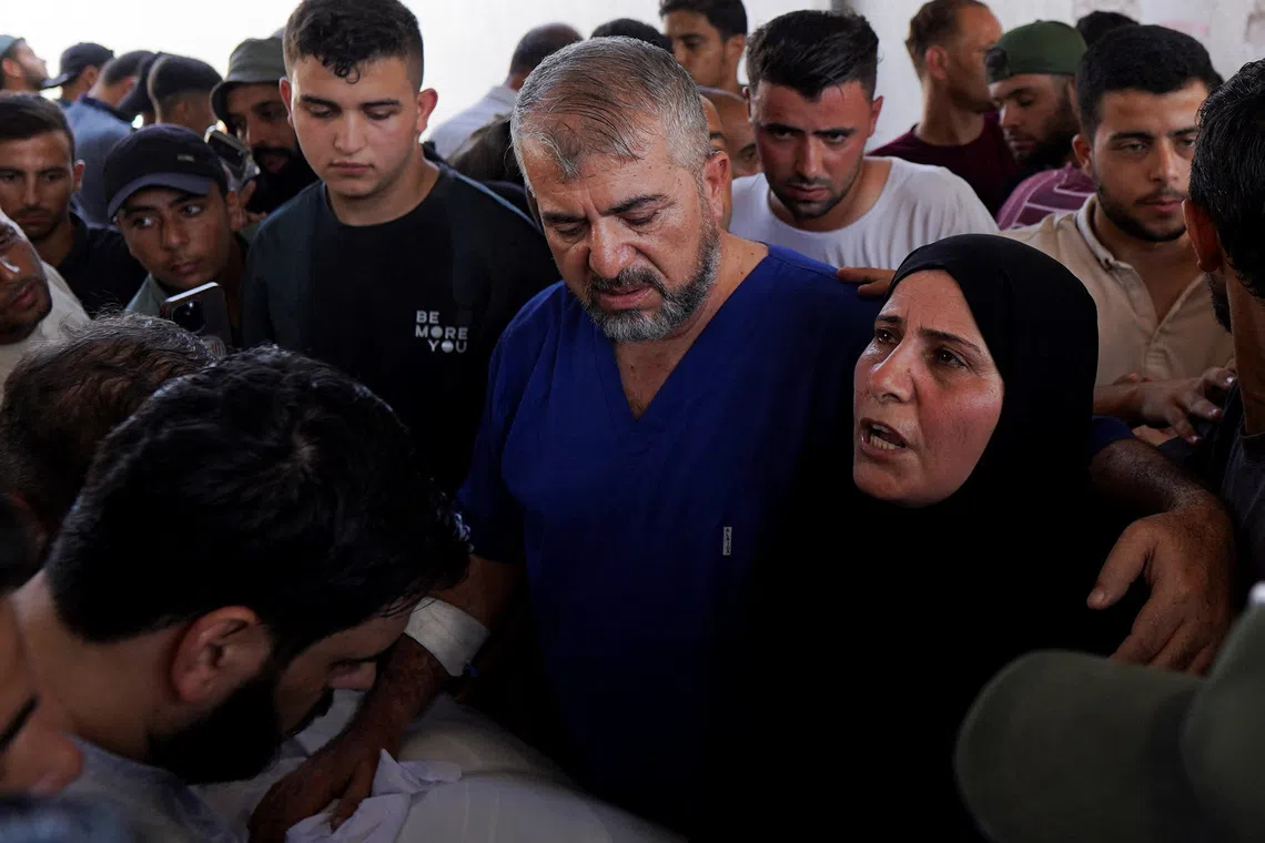 Munir Al-Bursh and his wife attending the funeral of their son Basir in Gaza City on Sept 19.