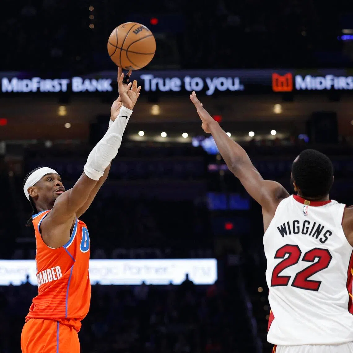 Oklahoma City Thunder guard Shai Gilgeous-Alexander shooting over Miami Heat forward Andrew Wiggins during the second half of the Thunder's 124-112 NBA home victory at Paycom Center on Jan 11, 2026.