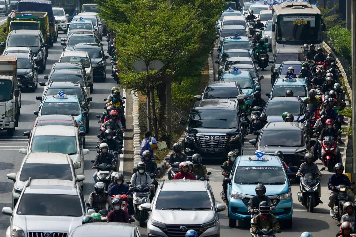 Traffic is seen during morning rush hour in Jakarta on August 21, 2023, the first day the local government began a remote working scheme for 50 percent of its employees to help reduce air pollution. (Photo by BAY ISMOYO / AFP)