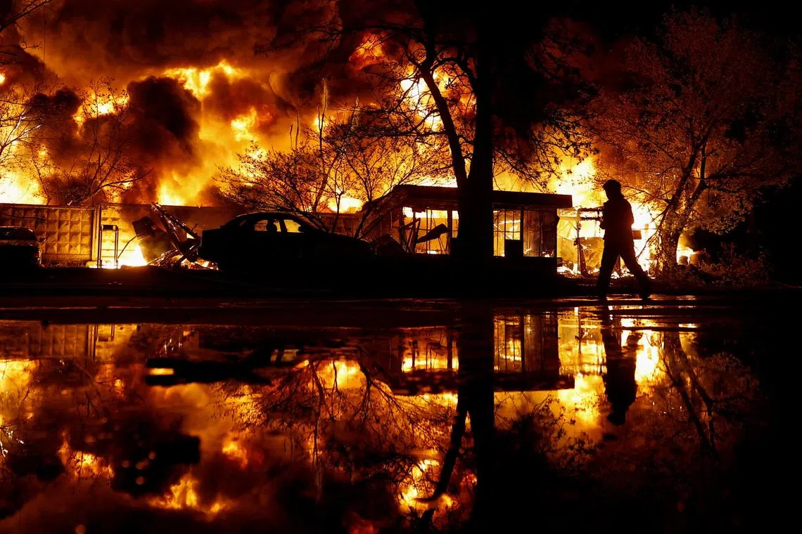 A firefighter works at the site of recycling materials hit by a Russian missile strike, amid Russia's attack on Ukraine, in Kyiv, Ukraine, April 16, 2026. REUTERS/Valentyn Ogirenko TPX IMAGES OF THE DAY
