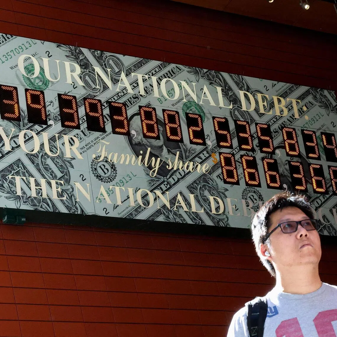 A man passing by the National Debt Clock in New York City on Aug 19. The US Treasury’s daily cash and debt balances statement showed total public debt outstanding at US$40.047 trillion on Aug 18.