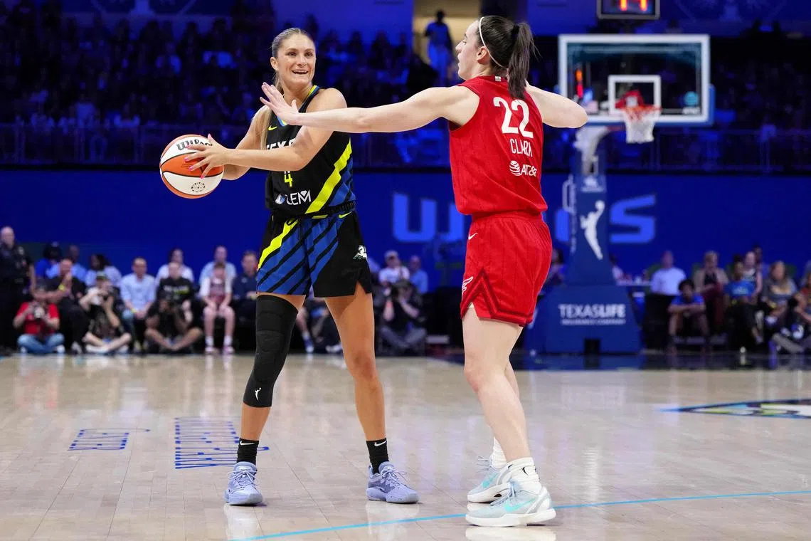 Jacy Sheldon of the Dallas Wings is defended by Caitlin Clark of the Indiana Fever in a WNBA match on Sept 1.