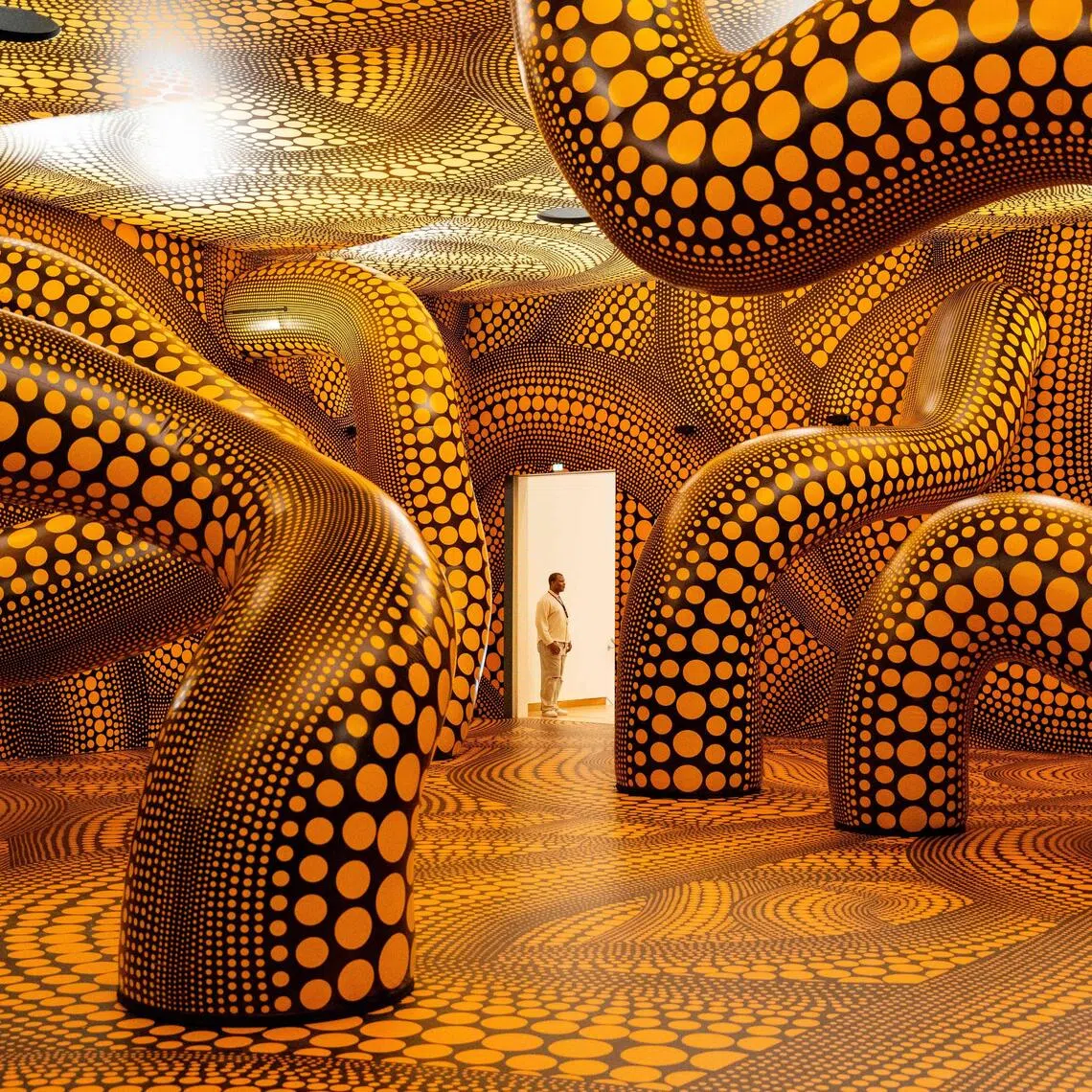 The exhibition at Amsterdam’s Stedelijk Museum features a huge “infinity room” with black walls covered by yellow polka dots.