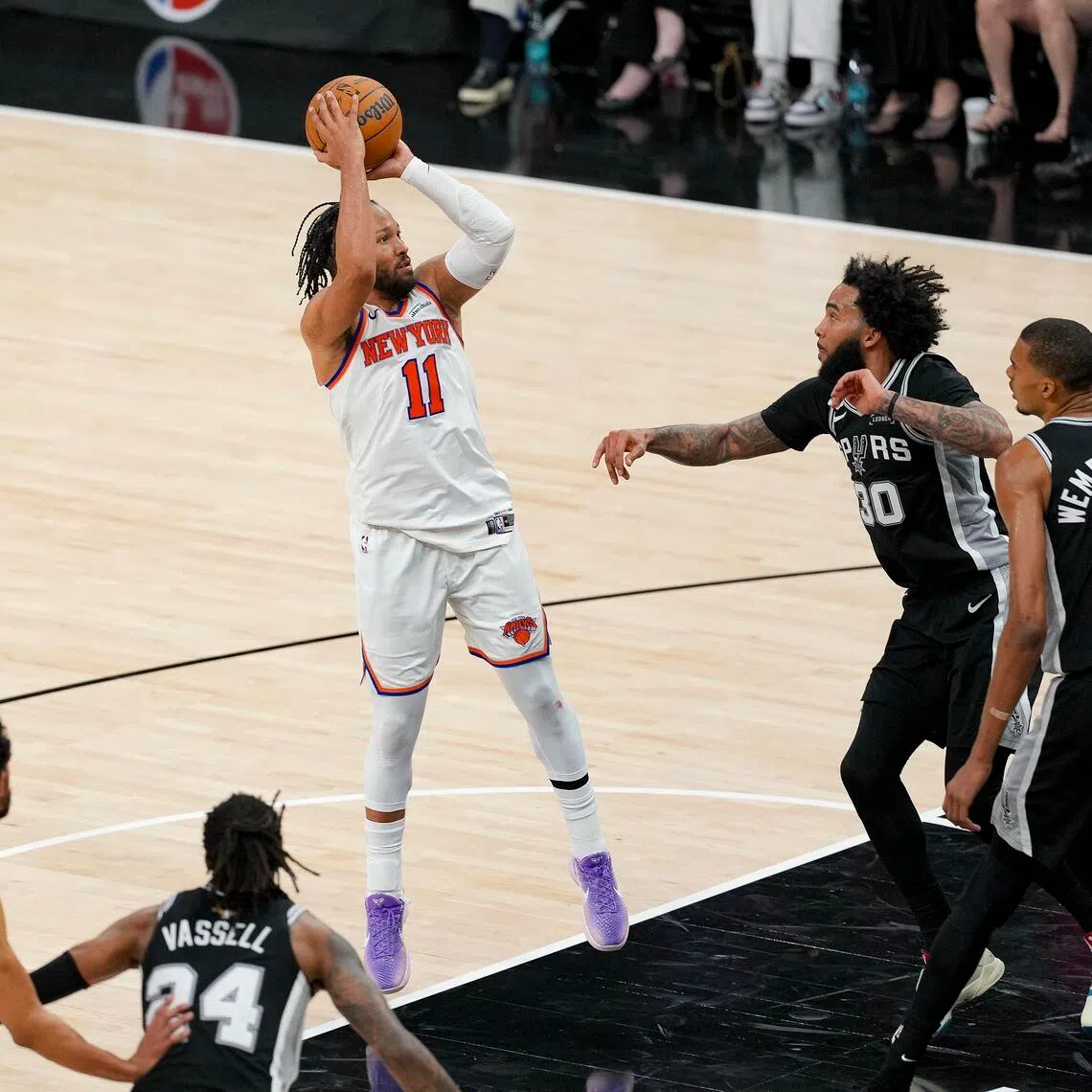 New York Knicks guard Jalen Brunson shoots the ball over San Antonio Spurs forward Julian Champagnie during the fourth quarter in Game 1 of the NBA Finals.