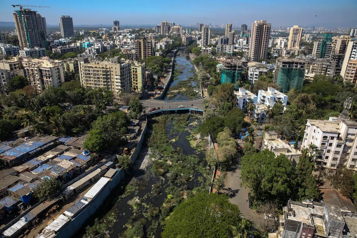 The polluted Dahisar River, passing through the residential building in Mumbai, India, March 6, 2024. Dahisar river has become highly polluted with sewage, silt, debris and plastic bags as a result of industrial polution as well as that from slums and residential complexes in its banks.